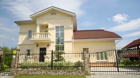 Modern two storey cottage with wrought fence at summer day Stock Footage 45227879