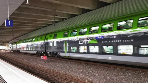 A modern two-tier train departs rapidly gaining speed. Time to travel concept Stock Footage 133591918