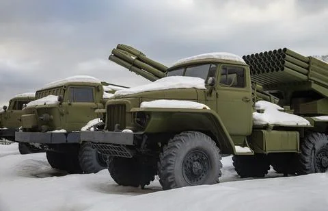 Modern types of multiple rocket launchers in the parking lot after  snowfall. Stock Photos