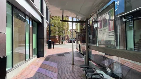 Modern UK Bus Stop with Double Decker Bus – Static City Street Shot Stock-Footage 332162749