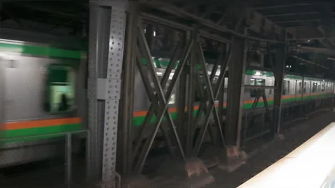 Modern underground metro train arriving at a station platform in Tokyo Stock Footage 330261606