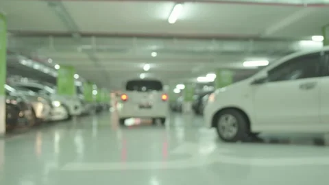 Modern underground parking with blurred unrecognizable moving cars 4K Stock Footage 251659441