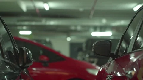Modern underground parking with unrecognizable moving cars, focusing on the Stock Footage 251658637