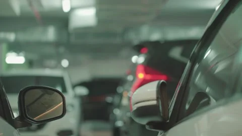 Modern underground parking with unrecognizable moving cars, focusing on the Stock Footage 251658990