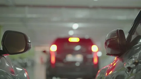 Modern underground parking with unrecognizable moving cars, focusing on the Stock Footage 251659220