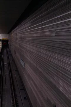 A modern underground passage with parallel lines and digital display board Stock Photos