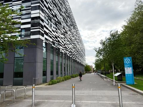 Modern university campus building with patterned facade and walkway in Manc.. Stock Photos
