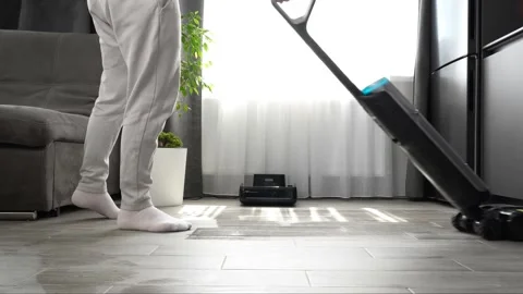 Modern upright floor cleaning machine operating on a tiled wooden surface Stock Footage 345023846