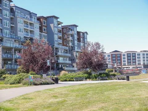 Modern upscale luxury condominium buildings with a green park lawn in Rusto.. Stock Photos