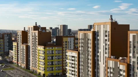A Modern Urban Apartment Complex Surrounded by Bright Daylight in the Cityscape Stock Footage 287231393