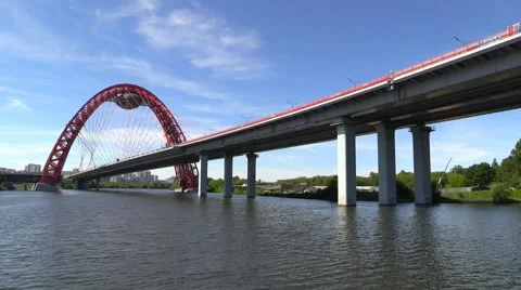 The modern urban car cable-stayed bridge over the river Stock Footage 51110596