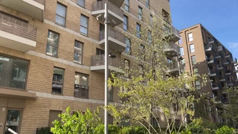 Modern urban development in the UK - facades of flats - gimbal shot Stock Footage 332558360
