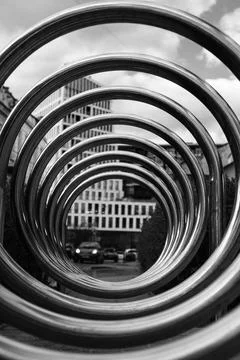 Modern urban scene of interlocking metal rings forming a circular pattern in the Stock Photos