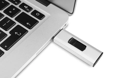Modern usb flash drive attached into laptop on white background, closeup Stock Photos