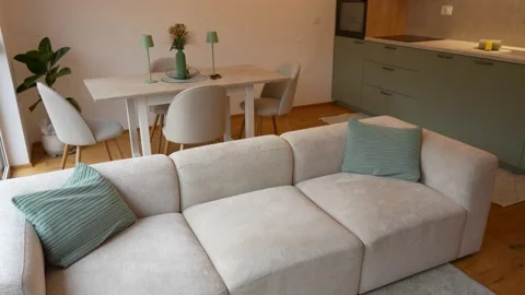 Modern Vacation Rental Interior With Sofa, Dining Table And Contemporary Kitchen Stock Footage 343959111