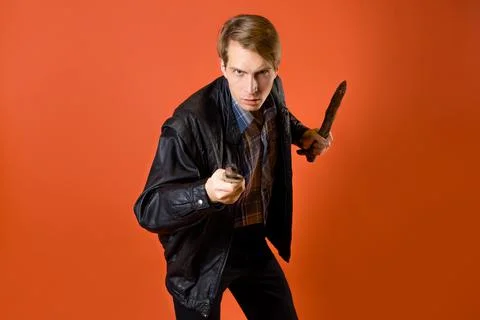 A modern vampire hunter, a guy in a casual shirt and a leather jacket Stock Photos