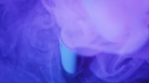 Modern Vape Pen in Clouds of Smoke with Purple Lighting Video stock 325878937