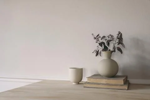 Modern vase with dry eucalyptus tree branches on wooden table. Cup of coffee 스톡 사진