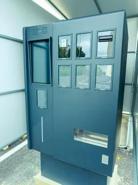 Modern vending machine placed outside in a covered area during daytime for .. Fotos de archivo