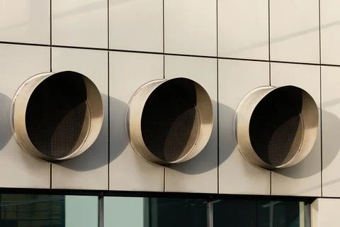 Modern ventilation system design on building facade Stock Photos