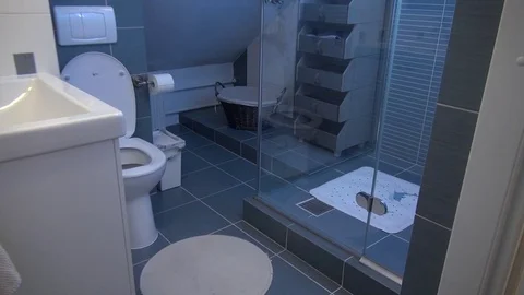Modern very small bathroom in house attic with shower and toilet Stock Footage 79593897