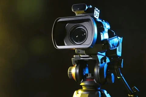 Modern video camera on black background, closeup. Space for text Stock Photos