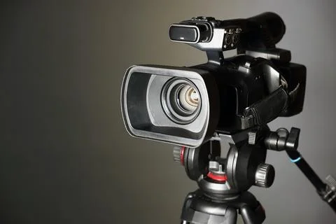 Modern video camera on grey background, closeup. Space for text Stock Photos