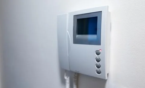 Modern Video Intercom System Mounted on white wall. Stock Photos