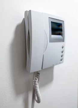 Modern Video Intercom System Mounted on white wall. Stock Photos