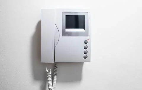 Modern Video Intercom System Mounted on white wall. Stock Photos