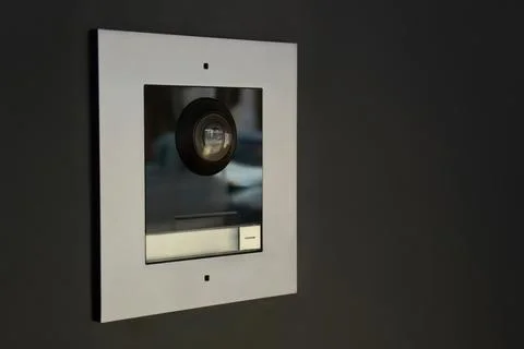 Modern video intercom system with speaker and access button indoors Stock Photos