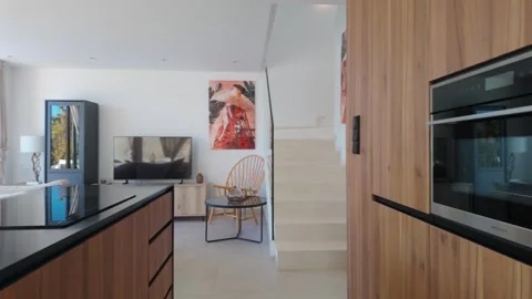 Modern villa kitchen view with stairs and natural light interior Stock Footage 324453369