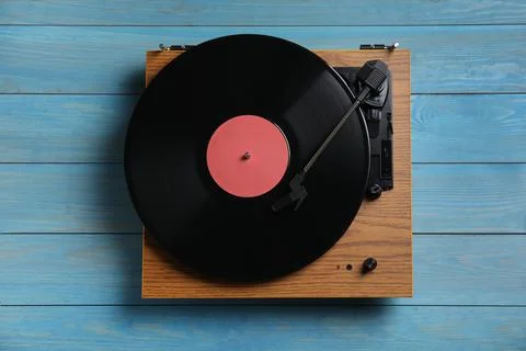 Modern vinyl record player with disc on blue wooden background, top view Stock Photos