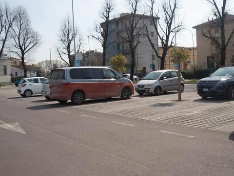 Modern VW Multivan T7 two tone orange and silver parked in concrete lot bes.. Stock Photos