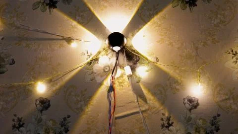 Modern Wall Light Casting Decorative Geometric Beam Pattern On Floral Wallpap Stock Photos