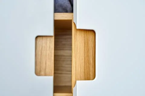 Modern wardrobe with finger pull design. Wooden wardrobe with light gray cabi Stock Photos