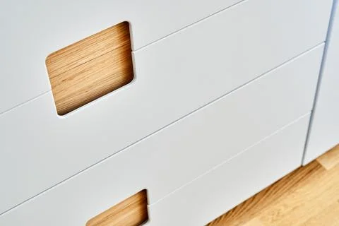 Modern wardrobe with finger pull design. Wooden wardrobe with light gray cabi Stock Photos