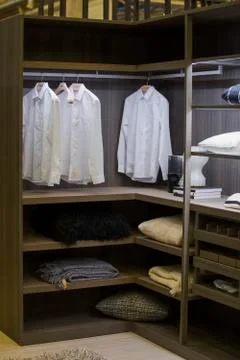 A modern wardrobe room with lighting, with examples of shelves for clothes in Stock Photos