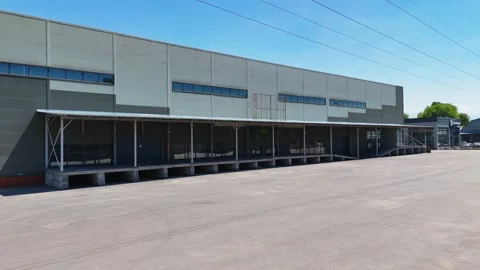 Modern Warehouse Building Exterior with Loading Docks Stock Footage 343256505