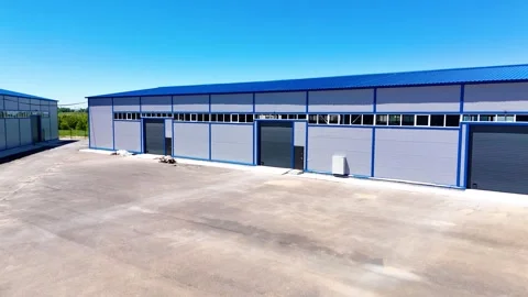 Modern Warehouse Buildings with Logistics Yard and Loading Area Between Stock Footage 340041753
