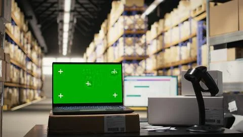 Modern warehouse facility featuring isolated workstation with chroma key display Stock Photos