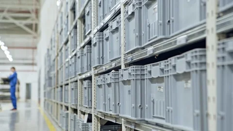 Modern warehouse with plastic gray boxes on the production. Video stock 95131410