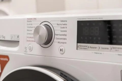 Modern washing machine control panel with program dial and digital display,.. Stock Photos