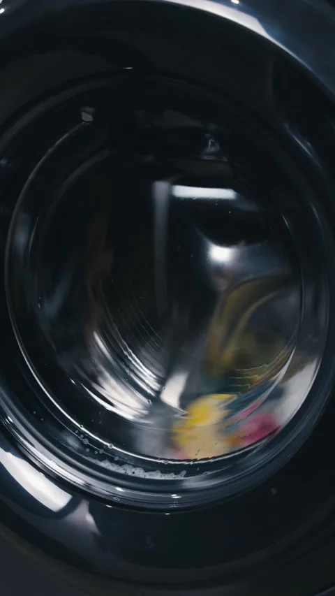 Modern washing machine drum spinning during a wash cycle, demonstrating Stock Footage 344911532