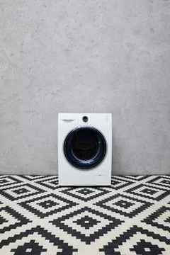 Modern washing machine grey wall Stock Photos