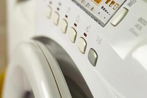 Modern washing machine with laundry. Close-up of control buttons and panel Stock Photos