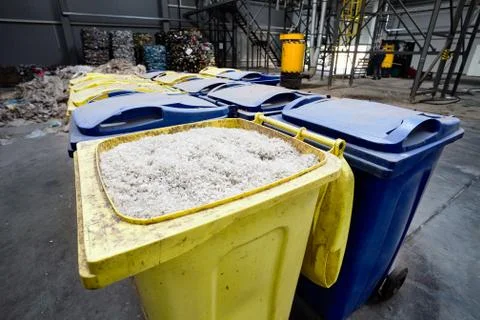 Modern waste processing and sorting plant. Containers with shredded plastic p Stock Photos