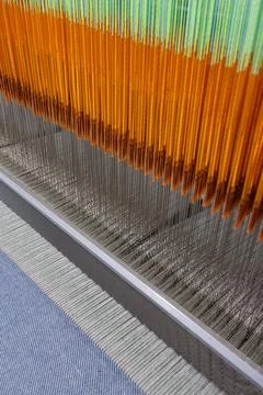 Modern weaving loom macro with warp threads, heddles and reed in textile pr.. Stock Photos