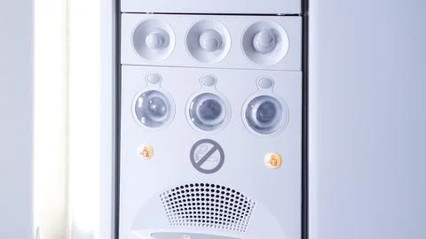 Modern white air conditioning unit with control panel and indicator lights Stock Photos