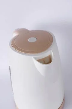 Modern white and brown automatic soap dispenser on white surface Stock Photos